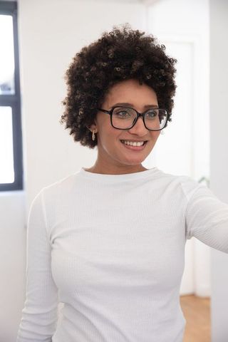 Woman Smiling Inside Office with Natural Light