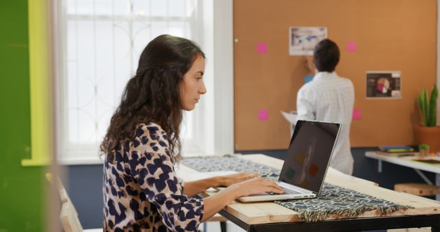 Young Woman Working on Laptop in Creative Office Space - Download Free Stock Images Pikwizard.com