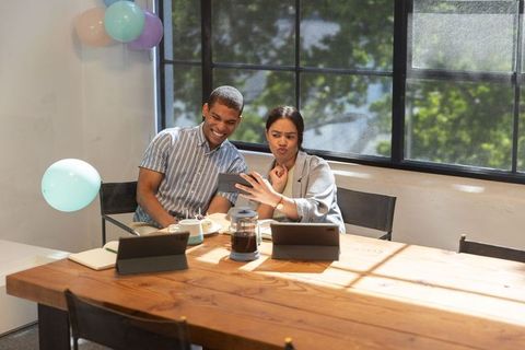 Diverse Coworkers Collaborating with Tablets in Modern Office Space