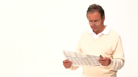 Senior Man Reading Newspaper with Focus and Interest
