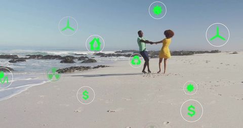 Couple dancing on beach interacting with eco symbols