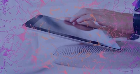 Hand interacting with tablet device on desk with network overlay