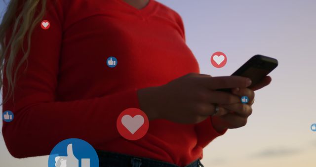 Young female engaging with social media on smartphone in evening light, with icons representing likes and hearts floating around. Perfect for illustrations of digital communication, online interactions, and modern lifestyle symbolism. Can be used for technology advertisements, social media campaigns, and articles focusing on youth and connectivity.