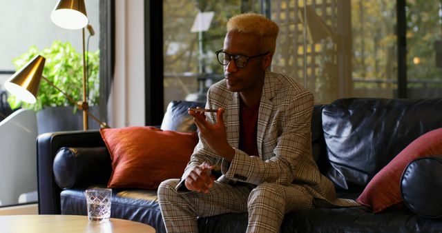 Young Man in Stylish Suit Talking on Phone in Modern Living Room - Download Free Stock Images Pikwizard.com