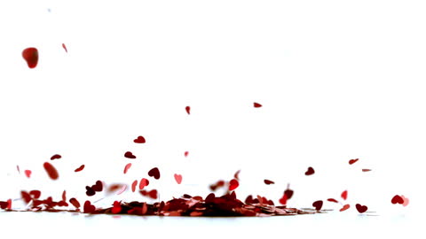 Red Heart Confetti Scattering Against White Background in Slow Motion