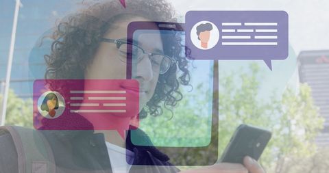 Young man messaging on smartphone with social media icons overlay