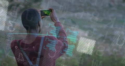 Person Capturing Scenic View Through Smartphone with Technology Overlays