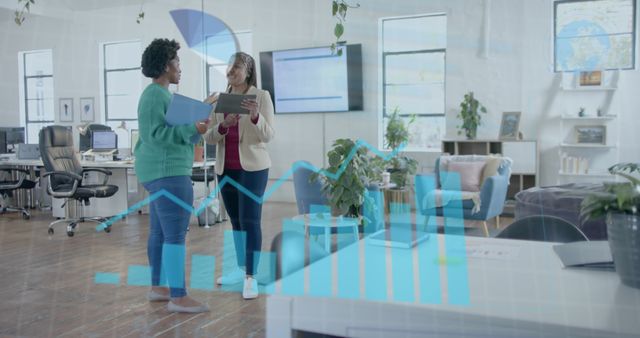 Businesswomen Analyzing Financial Data with Bar Graph Overlay; Modern Office Setting - Download Free Stock Images Pikwizard.com