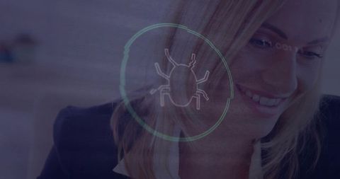 Smiling businesswoman checking monitor during cybersecurity bug scan overlay on futuristic interface