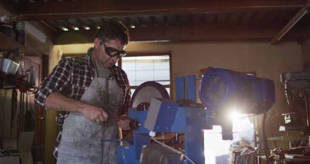 Craftsman Grinding Metal in Workshop with Safety Goggles - Download Free Stock Images Pikwizard.com