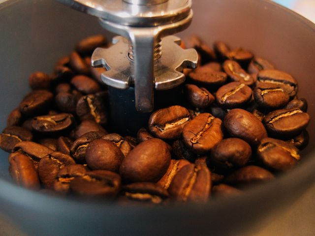 Close-Up of Coffee Beans Grinding in Coffee Grinder - Download Free Stock Photos Pikwizard.com