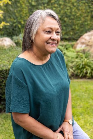 Elegant Senior Lady Relaxing Outdoors Enjoying Tranquil Garden