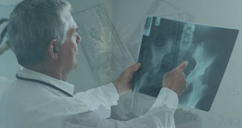 Doctor Examining X-Ray with Financial Technology Background