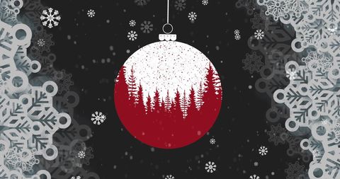 Festive red christmas ornament with snowy forest scene