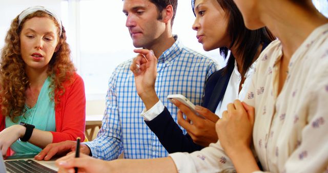 Diverse Team Collaborating on Laptop in Office Meeting - Download Free Stock Images Pikwizard.com