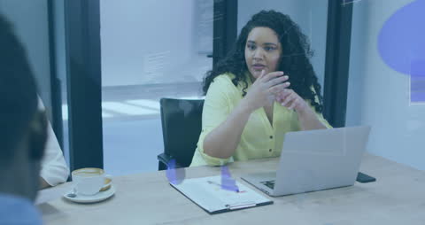 Diverse Business Team Discussing Data with Holographic Overlay