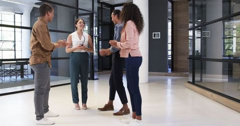 Diverse Group Celebrating Success in Modern Office