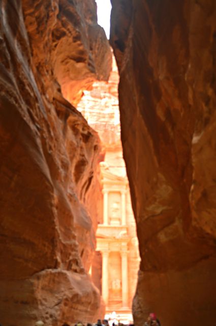 Tourists Entering Narrow Canyon Pathway to Iconic Jordan Petra - Download Free Stock Photos Pikwizard.com
