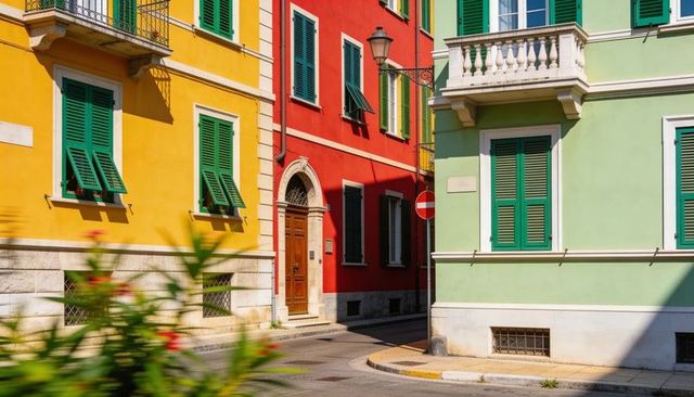 Sunlit mediterranean corner with colorful facades and green shutters casting shadows