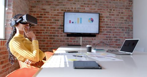 Businesswoman Engaging with Virtual Reality in Modern Office Environment