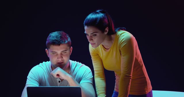 Focused Diverse Team Working on Laptop in Modern Office with Dark Background - Download Free Stock Images Pikwizard.com