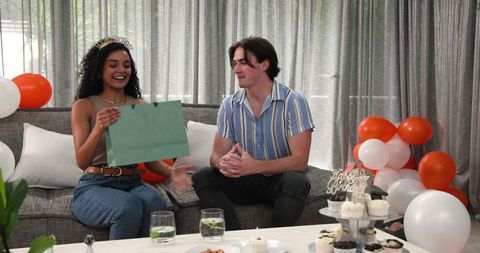 Couple Celebrating Birthday with Gift Exchange and Decoration
