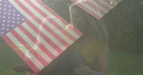 Mother and daughter embracing on lawn with american flag overlay patriotic family moment