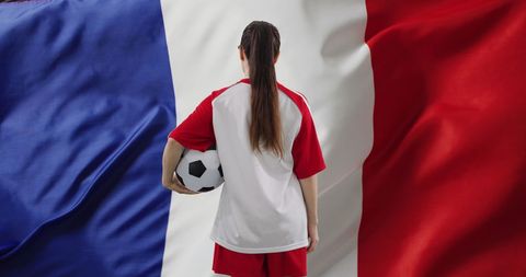 Female soccer player with french flag background