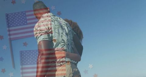 Couple Embracing Under Patriotic Graphics with American Flags
