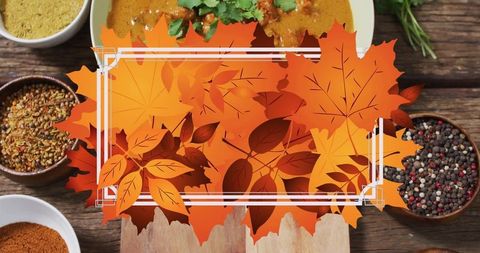 Bright autumn leaves overlaid above bowls of assorted spices and a curry dish. Ideal for use in fall-themed social media posts, food blog headers, seasonal cooking promotions, or digital menus emphasizing flavorful fall cuisine.