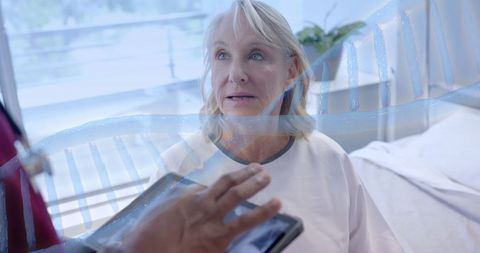 Senior female patient consults diverse doctor with digital dna interface