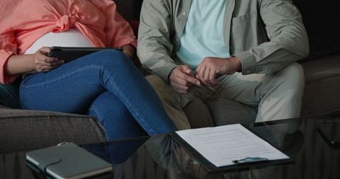 Couple reviewing wedding plans comfortably seated together