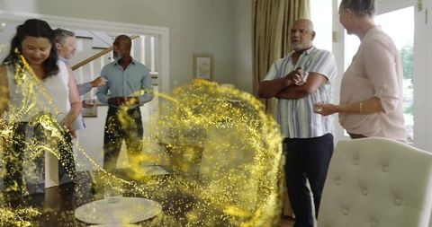 Adults gathering at home around dining table with golden particle hologram effect