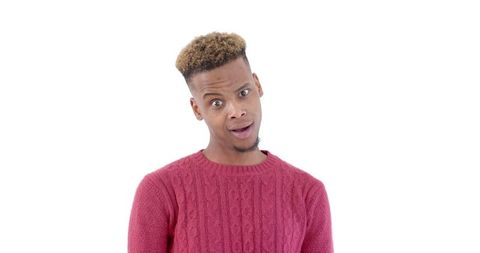 Surprised young man with shocked expression in red sweater