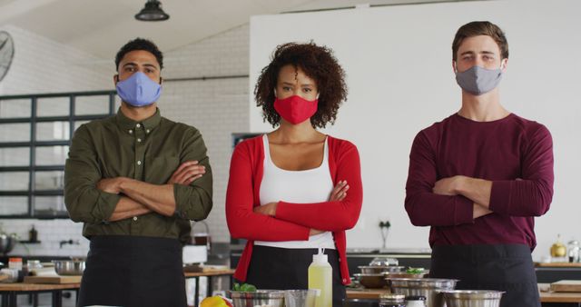 Confident multicultural chefs wearing masks in professional kitchen - Download Free Stock Images Pikwizard.com