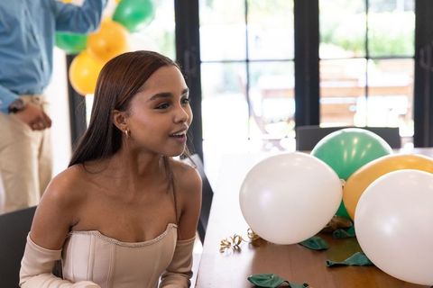 Young Woman at Lively Celebration Surrounded by Balloons