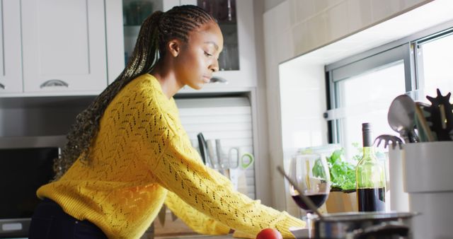 African american woman cleaning kitchen after cooking. Lifestyle, living, spending free time at home concept.