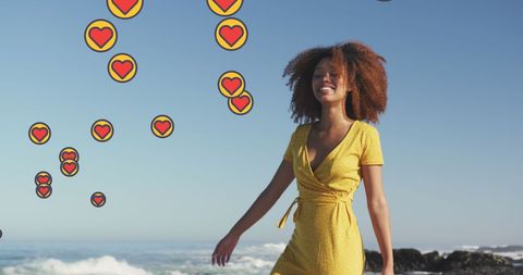Joyful Woman Dancing on Beach with Heart Emojis