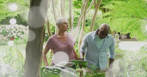 Senior Couple Walking Through Lush Garden Scenery