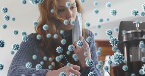 Young woman adjusting face mask amidst digital viruses