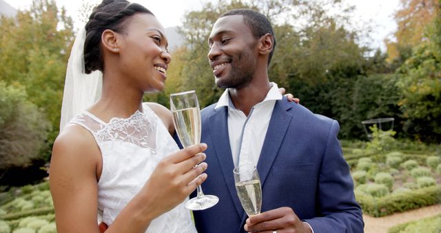 Joyful Newlyweds Toasting with Champagne in Garden - Download Free Stock Images Pikwizard.com