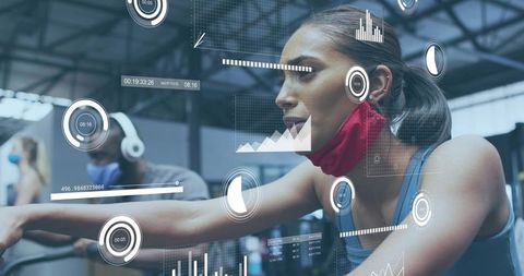 Female athlete pedaling on stationary bike with augmented reality fitness hud and mask
