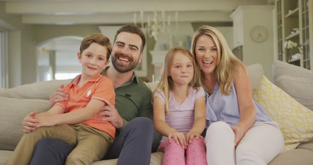 Happy Family Smiling and Laughing Together on Sofa at Home - Download Free Stock Images Pikwizard.com