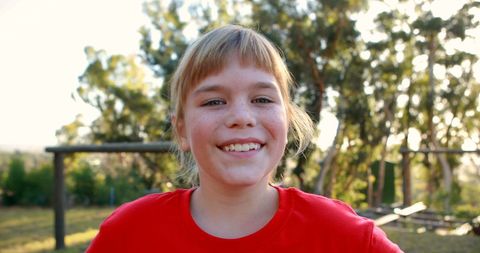 Confident Girl Smiling Outdoors in Bright Red Shirt - Download Free Stock Images Pikwizard.com