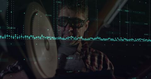 Machinist operating grinder with data visualization overlay