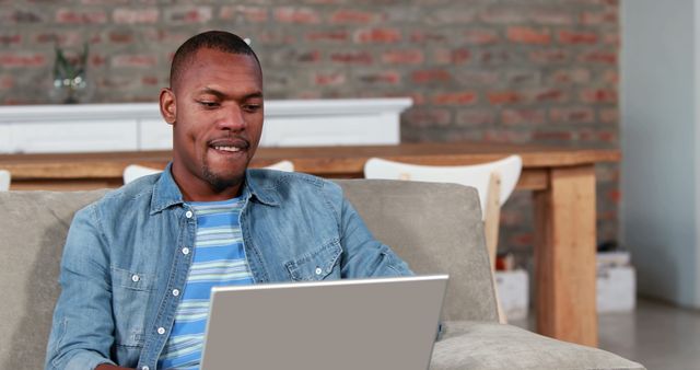 Casual African American man using laptop at home - Download Free Stock Images Pikwizard.com