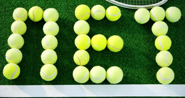 Close-up of tennis balls forming word net in court 