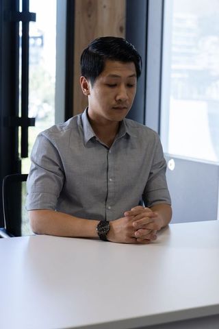 Contemplative Professional in Modern Office Space Overlooking Skyline