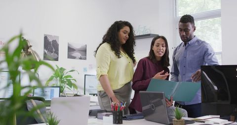 Multiracial team collaborating in modern office