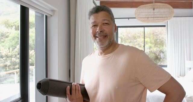 Happy Senior Man with Yoga Mat in Bright Living Room - Download Free Stock Images Pikwizard.com